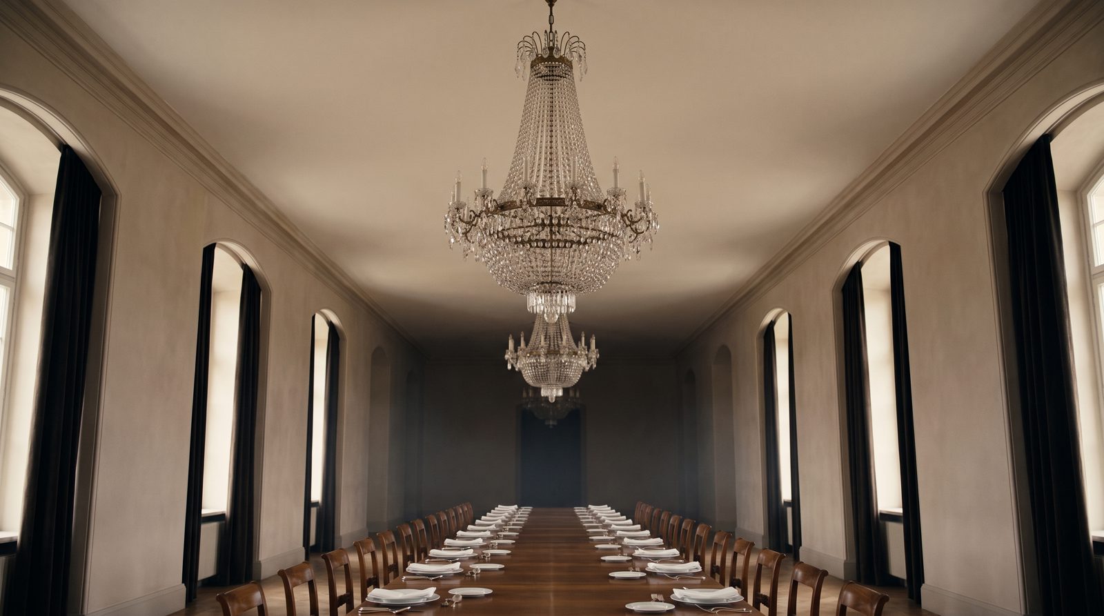 The Golden Hall at dusk — a crystal chandelier over a long ceremonial table