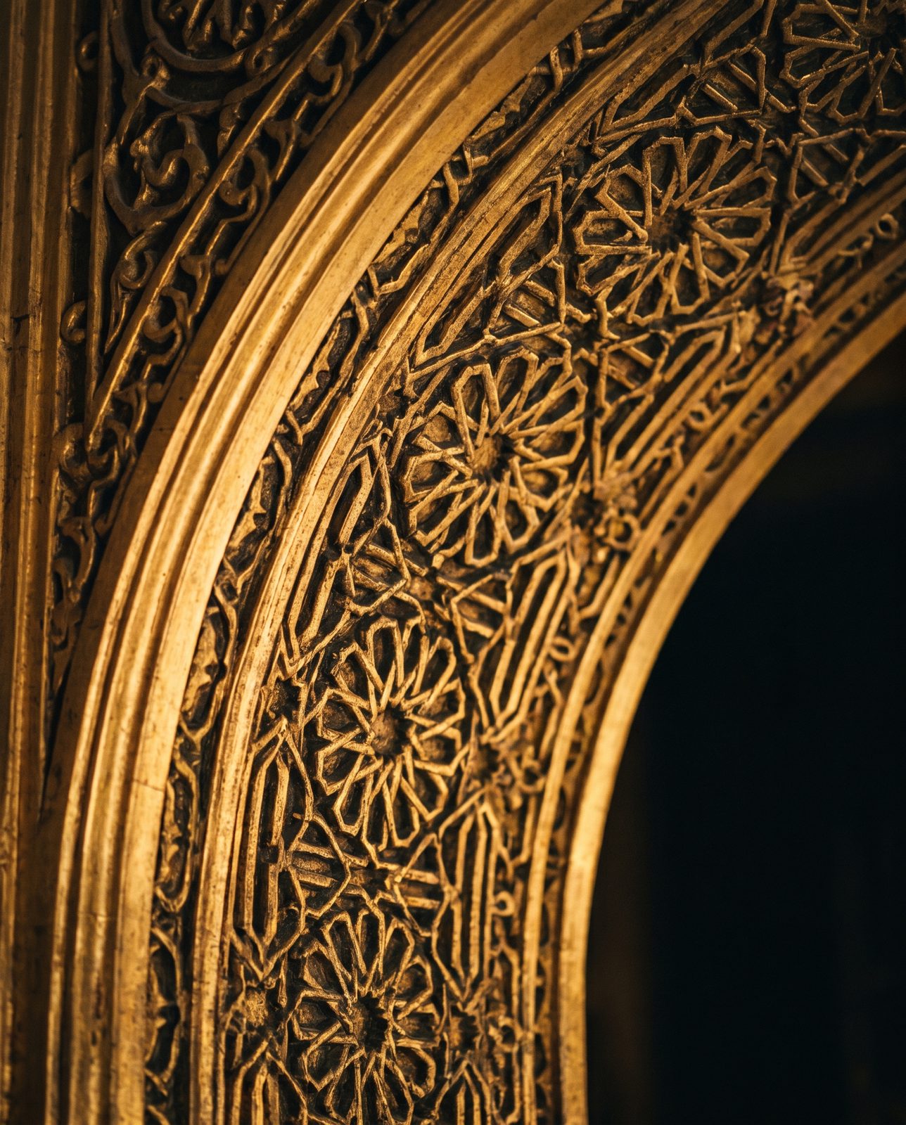 Carved gilded arch with dense octagonal fretwork